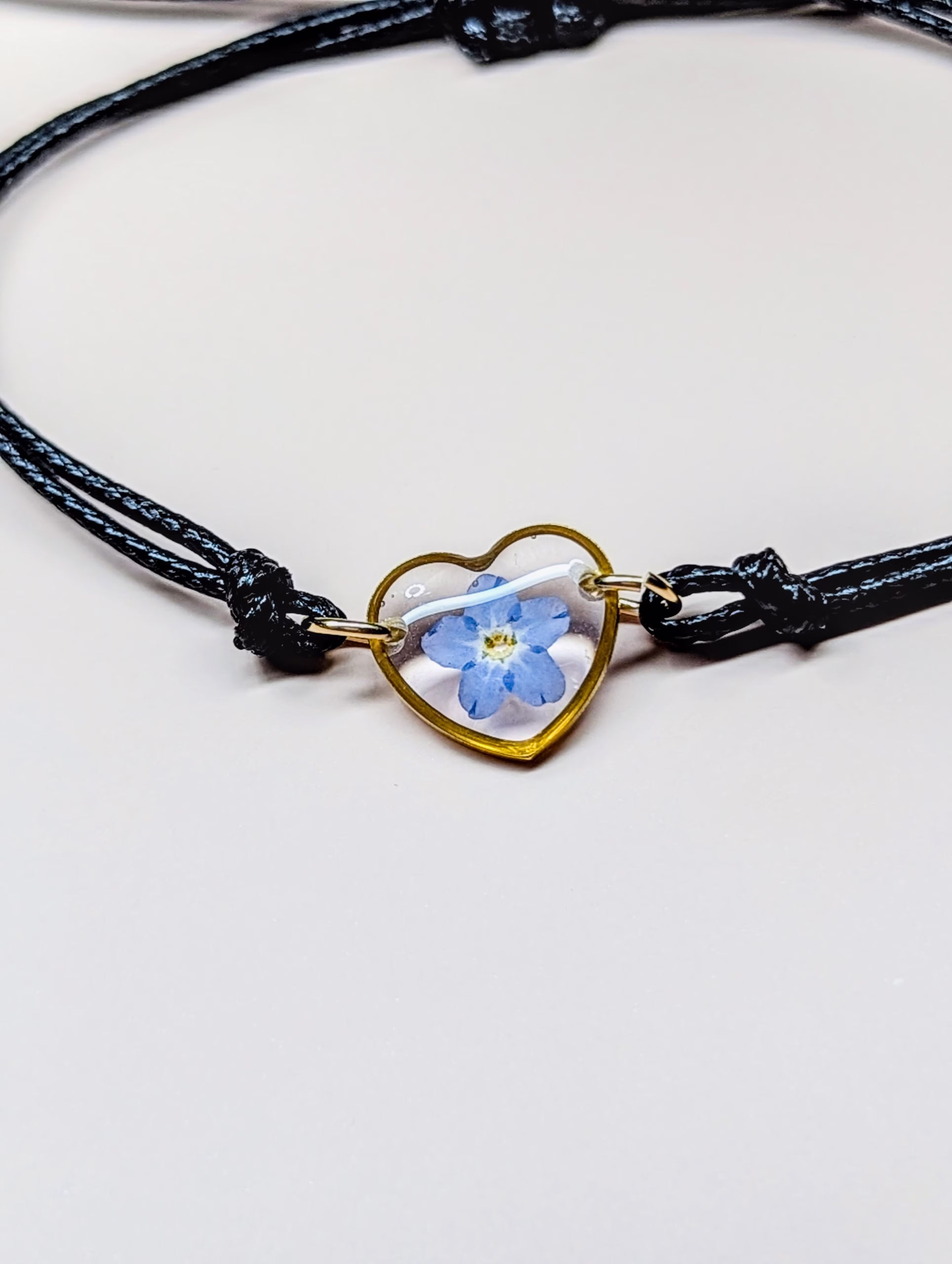Forget me not black cord bracelet in gold - Image 2