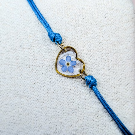 Forget me not blue cord bracelet in gold